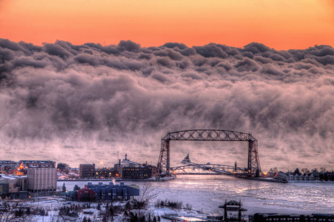 A view of the Aerial Liftbridge in Duluth with Lake Superior in the distance, the clouds coming off the water look like giant waves